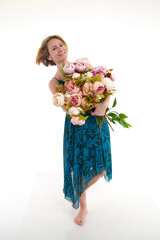 Pretty skinny girl with beautiful flowers on a white background in photo studio