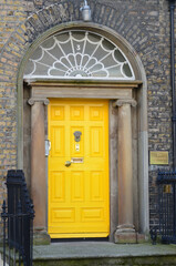 Fototapeta na wymiar Brilliant Yellow Door on Georgian Town House in Dublin