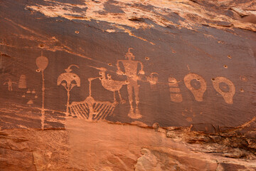ancient native american wolfman petroglyph panel in comb ridge, near bluff,  utah