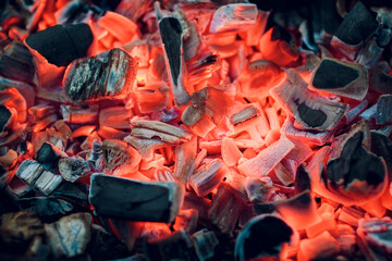 Burning coals. Decaying charcoal. Texture embers closeup. burning charcoal in the background....