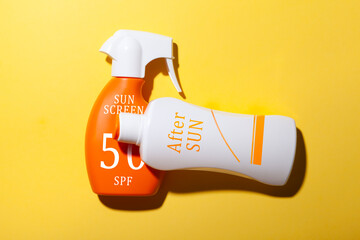 top view of  Sun screen and after sun lotion set on yellow background. summer care concept.