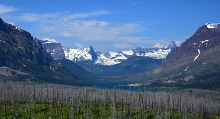 Fototapeta na wymiar spectacular panorama of fusillade mountain, gunsight ridge, reynolds mountain, st. mary lake and forest fire damage in glacier national park, montana, on a sunny day 