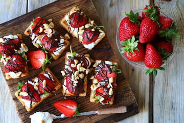 Delicious waffles with strawberries, chocolate and white cheese. Healthy dessert.