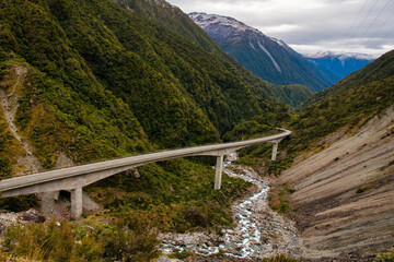 Highway through the mountains on Arthurs Pass viaduct winding through the rugged Otira Gorge