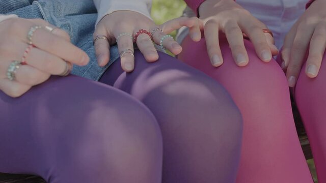 Teenagers dressed in bright tights. Video of details where only tights and girls' hands are visible.