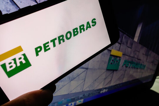 Petrobras company (Petroleo Brasileiro SA) logo visible on smartphone screen, with picture of its headquarter building on background