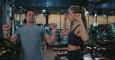 Fitness coach talking explaining training bench press weightlifting with barbell program to woman...