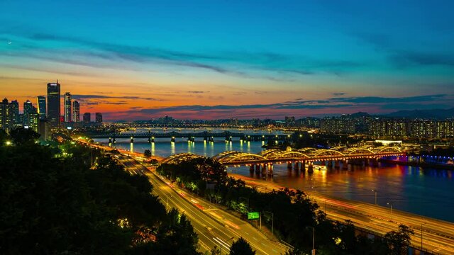 Seoul sunset viewpoint overlooking modern tall buildings with island nodeul and the Han River There is a tourist boat See the atmosphere at nigth  in South Korea.