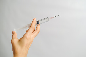 Hand holding syringe contain vaccine or medicine for injection
