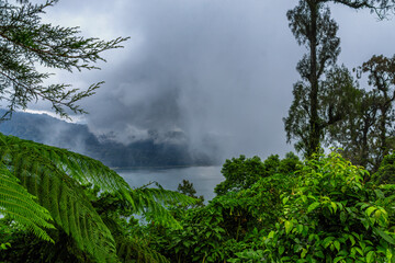 View of Lake Buyan on a misty day on Bali island, Indonesia.  the second biggest lake in bali ...