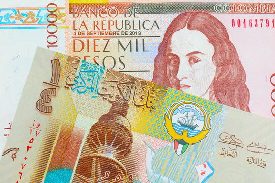 A macro image of a brown ten thousand bank note from Colombia paired up with a colorful, plastic quarter dinar from Kuwait.  Shot close up in macro.