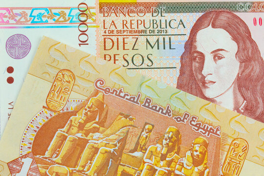 A macro image of a brown ten thousand bank note from Colombia paired up with a one pound banknote from Egypt.  Shot close up in macro.
