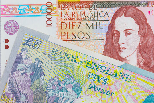 A macro image of a brown ten thousand bank note from Colombia paired up with a colorful, five pound bank note from the United Kingdom.  Shot close up in macro.