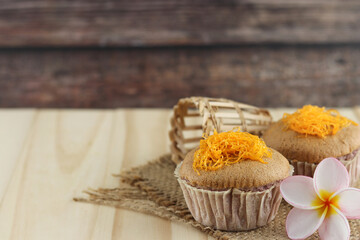 Foi Thong banana cake (Fios de ovos), Thai traditional cusine dessert from yolk on wooden background.