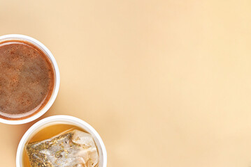 Two cups with coffee and green tea.