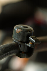 a pushbike bell that is old and rusty with paint chipping off and rust showing through