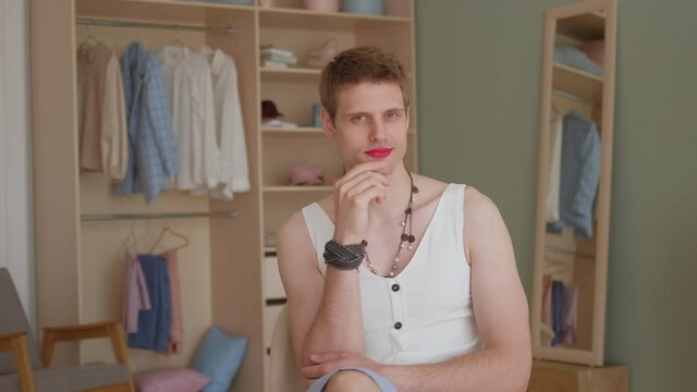 Portrait young smiling transgender transsexual gay man applying make-up looking at camera. LGBTQ Man wearing women's clothing with makeup. womanlike man on face and woman clothes, fashion glamorous