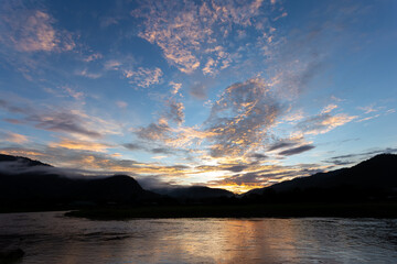 landscape river mountain sky orange clouds sunset evening mountain silhouette for refreshing background