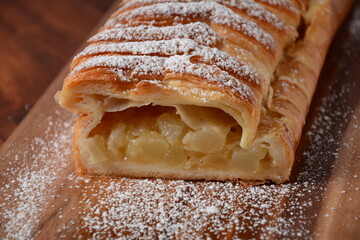 Austrian strudel with mint and with powdered sugar on a plate. Cake with apple jam