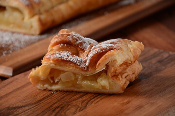 Austrian strudel with mint and with powdered sugar on a plate. Cake with apple jam