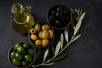 Olives, olive branch ,Olive oil on wooden background