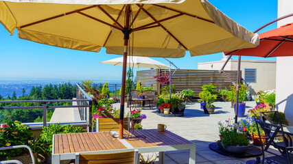 Multiple umbrellas provide much needed shade on patio garden during height of record-breaking BC heatwave.