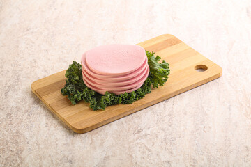 Slices pork sausage over board