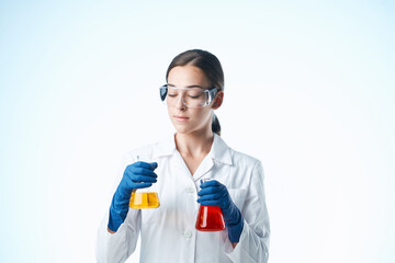 female laboratory assistant in white coat chemical solution research science