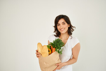 cheerful brunette with a package of groceries healthy food delivery