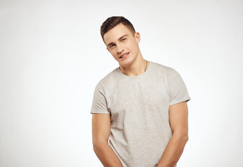 handsome man in light t-shirt cropped view studio lifestyle