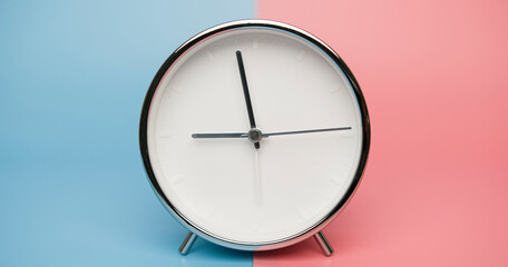 Alarm clock isolated on blue pink background, Copy space for your text, Time concept.