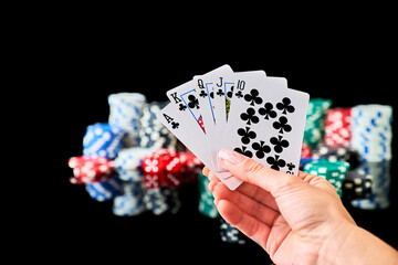 Casino chips, playing cards and dices on dark reflective background