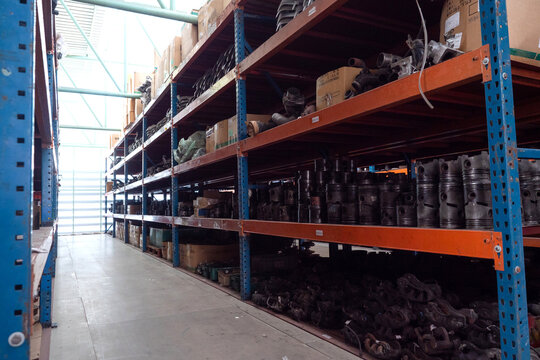 Warehouse interior with shelves part of car.