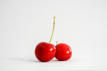 Side view of cherries on white background
