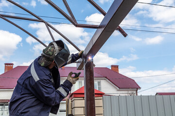 A worker welds metal to the canopy. Technologies
