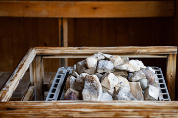 Pile sauna stones in sauna room.