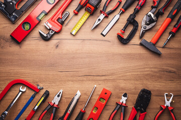 Assorted work tools on wooden background