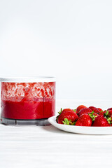 Strawberries Smoothie in blender on white background