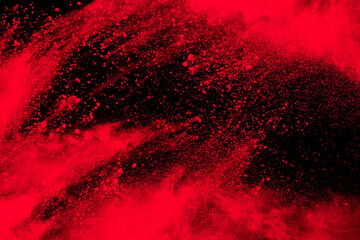 Red particle explosion on black background.Freeze motion of red dust splash.