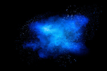 Blue color dust particle explosion cloud on black background.Color powder splash.