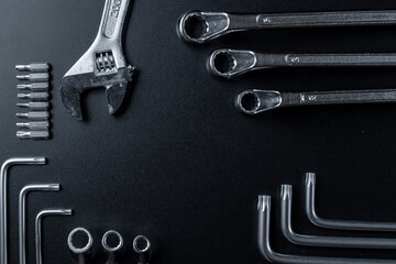 Fototapeta premium Metal tools. Metallic wrenches for home manual repair work. Set of hardware tool for construction on dark background. Construction tooling board with copy space maintenance concept.