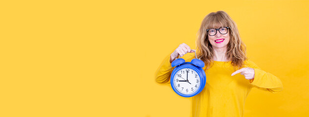 woman pointing finger at alarm clock isolated