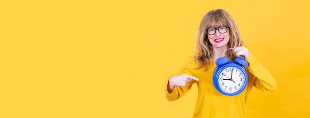 woman pointing finger at alarm clock isolated