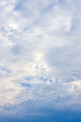 Fototapeta na wymiar Bright white cloudy sky vertical view