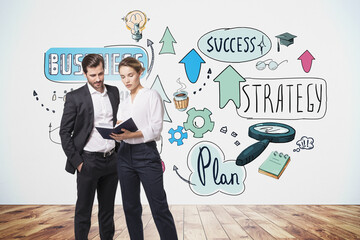 Businessman and businesswoman in formal clothes holding a book a