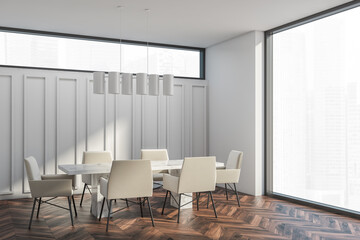 Corner of white room with table on dark brown parquet