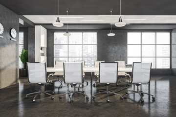 Office table with chairs in the interior with concrete design elements