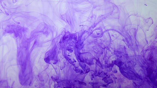 Purple ink diffusing in water, abstract smoke, slow motion
