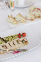 Table setting for a banquet or celebration. Empty wine glasses for spirits, champagne and juice. Set the table. Cloth napkins on a platter. Banqueting hall. Cold appetizers and salads