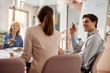 Fototapeta premium Happy male entrepreneur having business meeting with female coworkers in the office.